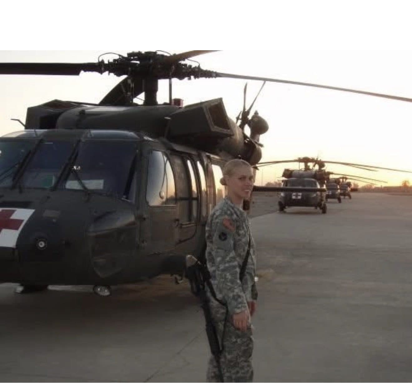 Jessica Frazier in uniform beside a MEDEVAC Black Hawk helicopter